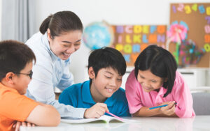 Teacher guiding students through interactive learning at a learning centre.