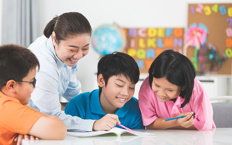 Teacher guiding students through interactive learning at a learning centre.