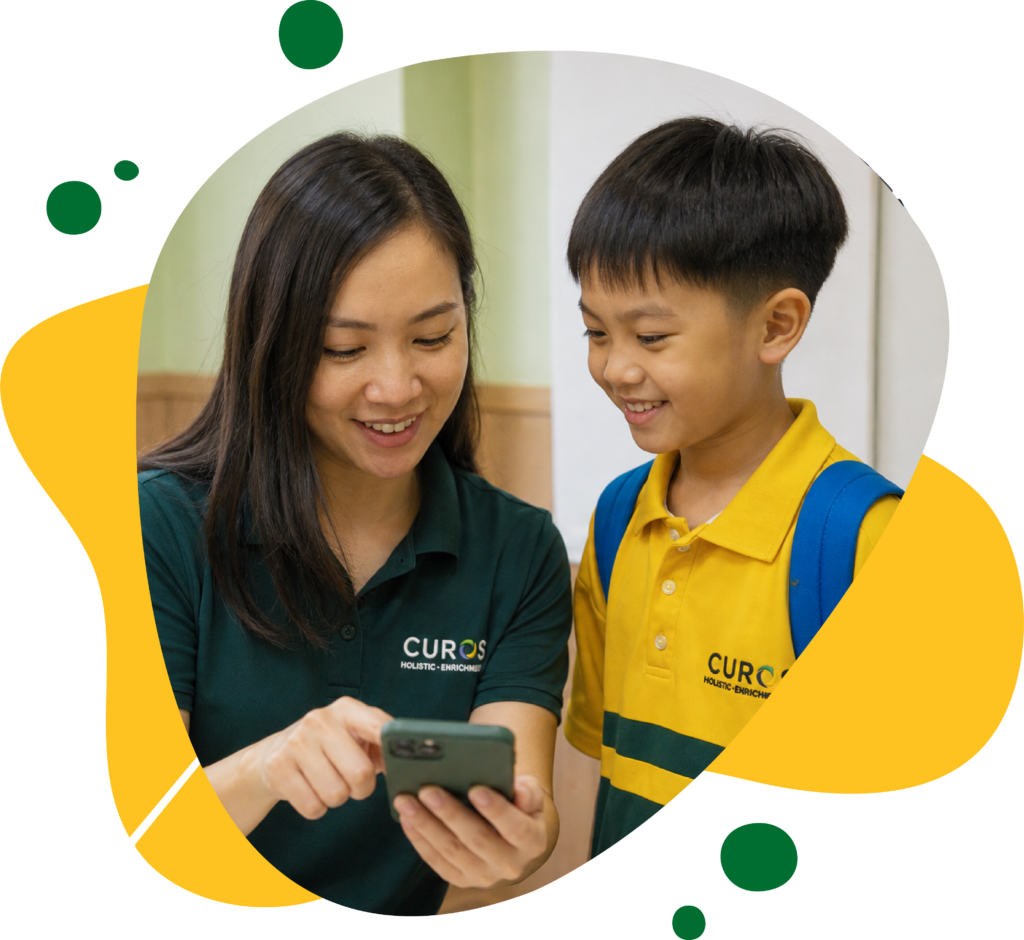 Smiling teacher shows a student something on a smartphone; he wears a yellow uniform and blue backpack in a warm, playful graphic.