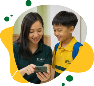 Smiling teacher shows a student something on a smartphone; he wears a yellow uniform and blue backpack in a warm, playful graphic.
